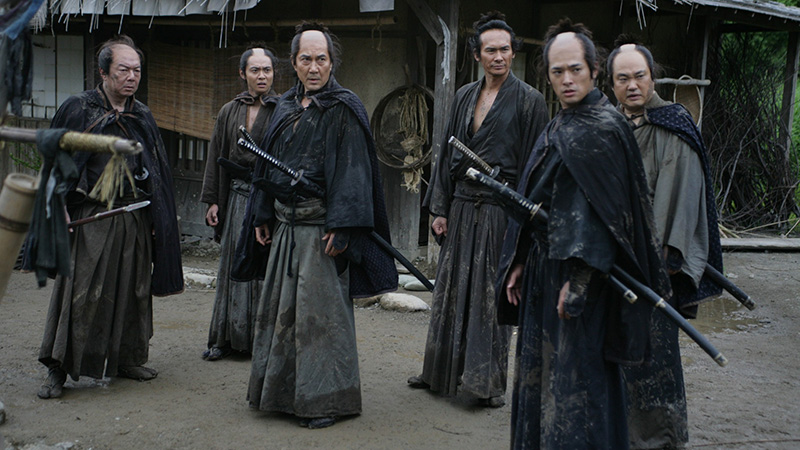The assassins stand together with this swords in a still from 13 Assassins.