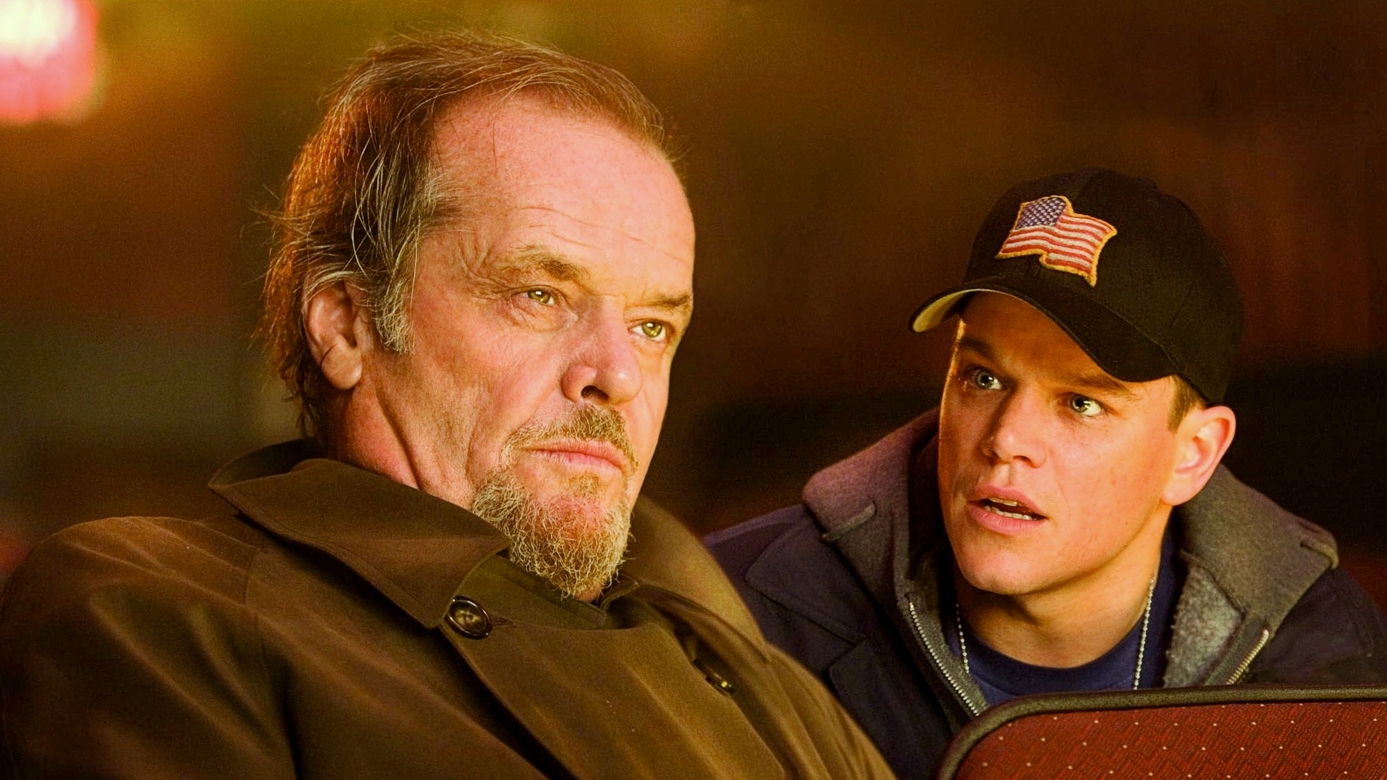 A still from The Departed featuring Matt Damon and Jack Nicholson in a movie theater.